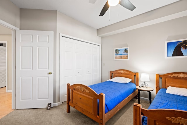 carpeted bedroom featuring ceiling fan and a closet