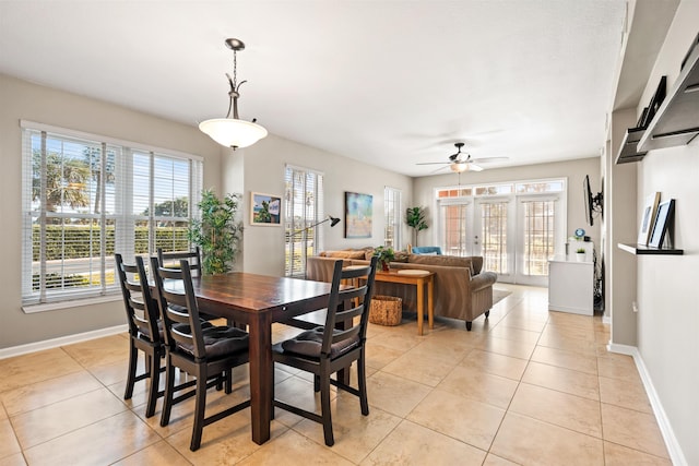 dining space with light tile patterned floors and ceiling fan