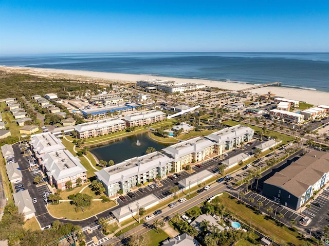 aerial view with a water view and a beach view