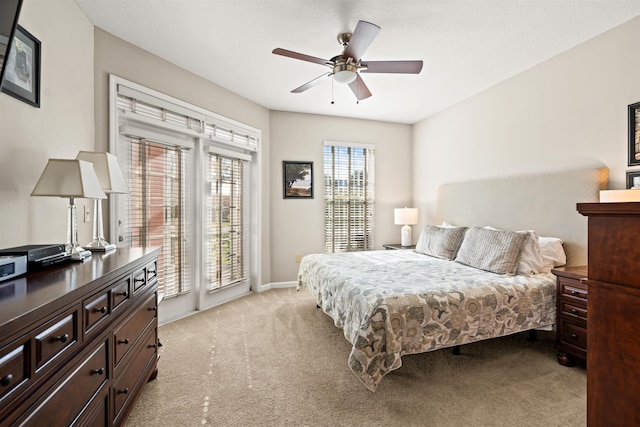 bedroom featuring ceiling fan and light carpet