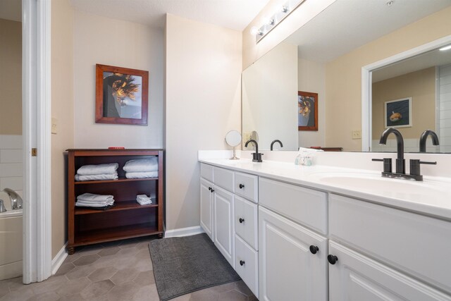 bathroom with tile patterned flooring and vanity