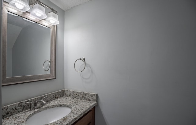 bathroom with a textured ceiling and vanity