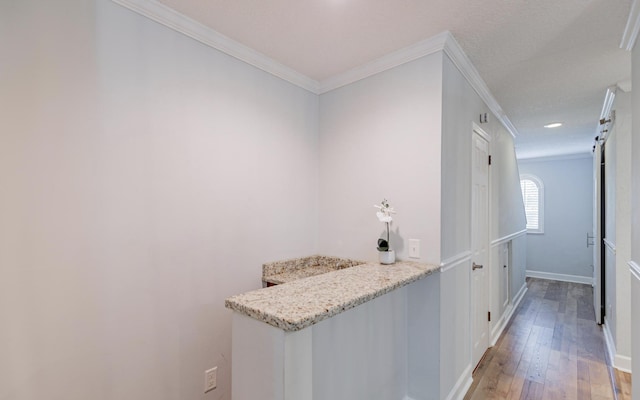 bar with crown molding, white cabinets, light hardwood / wood-style floors, and light stone counters