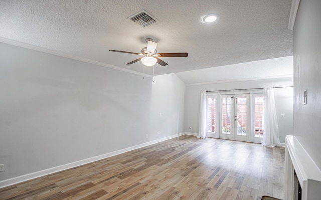 spare room featuring ceiling fan, french doors, crown molding, light hardwood / wood-style floors, and a textured ceiling