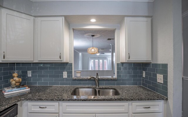 kitchen with backsplash, sink, white cabinets, and pendant lighting