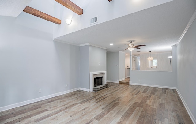 unfurnished living room with ceiling fan, light wood-type flooring, and ornamental molding