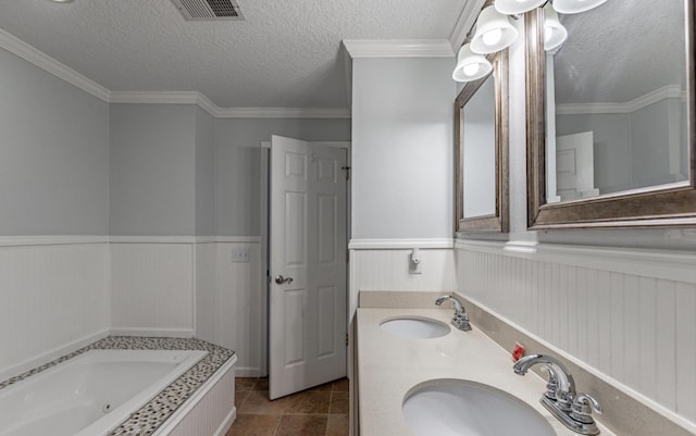 bathroom featuring tile patterned flooring, a textured ceiling, a bathtub, vanity, and ornamental molding