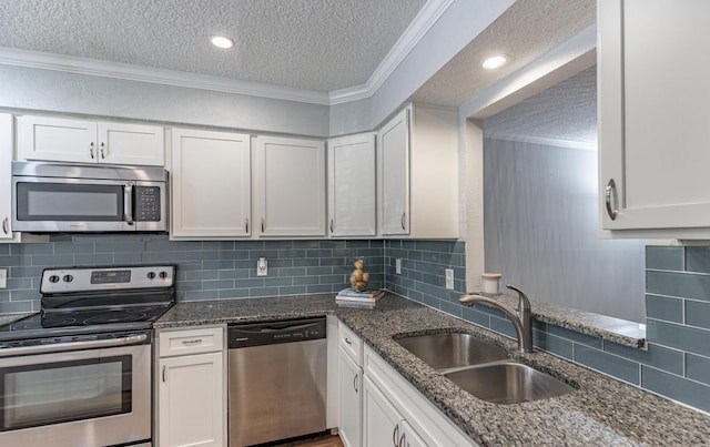 kitchen featuring white cabinets, a textured ceiling, and appliances with stainless steel finishes