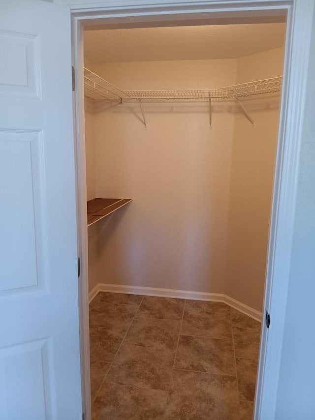 spacious closet featuring tile patterned floors