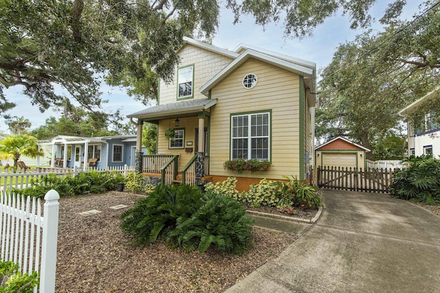 view of front of home with an outbuilding, a porch, and a garage