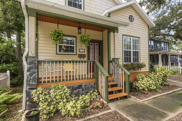 view of exterior entry featuring a porch