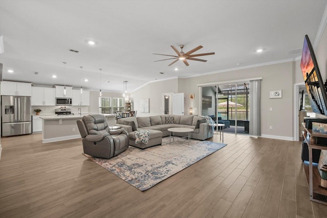 52 Lumberjack Trl, Palm Coast, FL 32137 - living area featuring healthy amount of natural light, ornamental molding, light wood-style flooring, a ceiling fan, and recessed lighting