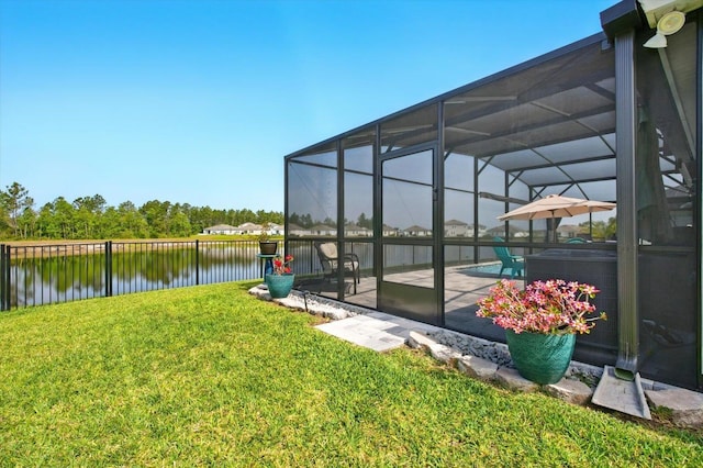 52 Lumberjack Trl, Palm Coast, FL 32137 - view of grassy yard featuring a water view, glass enclosure, and a patio