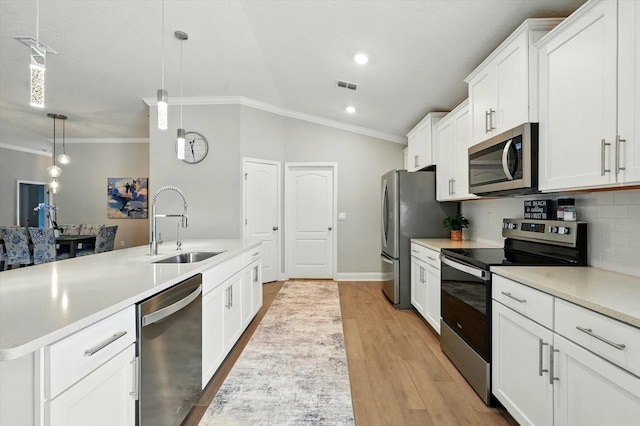 52 Lumberjack Trl, Palm Coast, FL 32137 - kitchen featuring appliances with stainless steel finishes, ornamental molding, light countertops, white cabinetry, and decorative backsplash