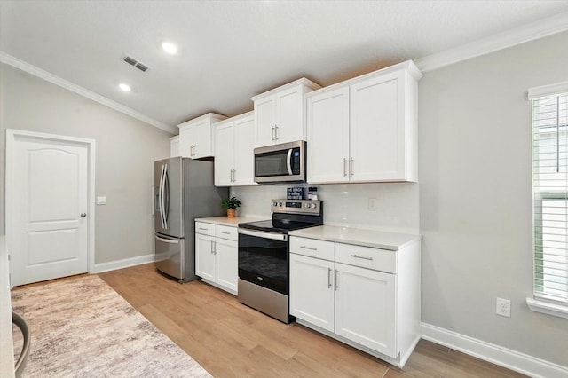52 Lumberjack Trl, Palm Coast, FL 32137 - kitchen with stainless steel appliances, ornamental molding, light wood-style floors, light countertops, and recessed lighting