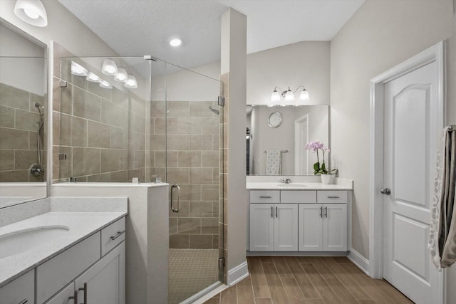 52 Lumberjack Trl, Palm Coast, FL 32137 - bathroom featuring two vanities, a stall shower, wood finished floors, and recessed lighting