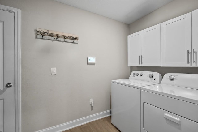 52 Lumberjack Trl, Palm Coast, FL 32137 - washroom with washing machine and dryer, cabinet space, and wood finished floors