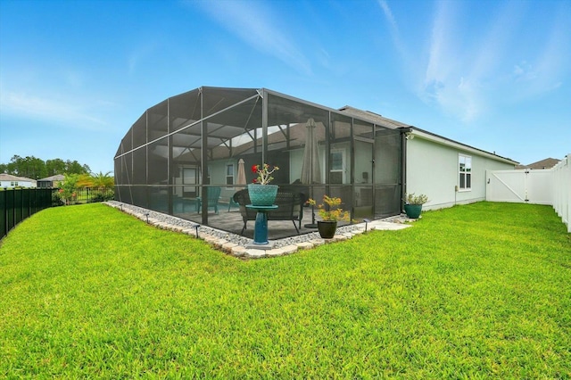 52 Lumberjack Trl, Palm Coast, FL 32137 - back of property with a fenced backyard, a patio, stucco siding, glass enclosure, and a gate