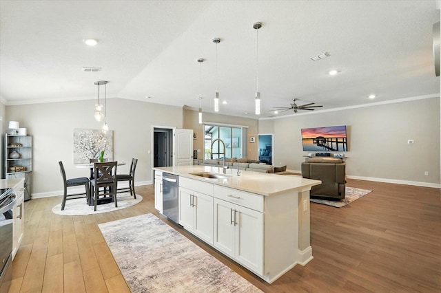52 Lumberjack Trl, Palm Coast, FL 32137 - kitchen with appliances with stainless steel finishes, light wood-style flooring, a ceiling fan, white cabinets, and light countertops