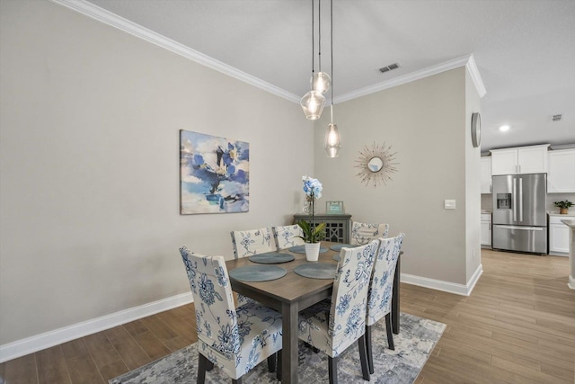 52 Lumberjack Trl, Palm Coast, FL 32137 - dining area with ornamental molding, light wood-style flooring, and recessed lighting