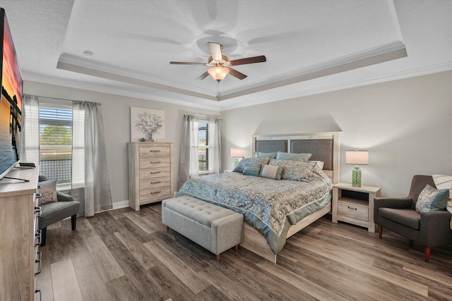 52 Lumberjack Trl, Palm Coast, FL 32137 - bedroom with a tray ceiling, multiple windows, wood finished floors, ornamental molding, and a textured ceiling