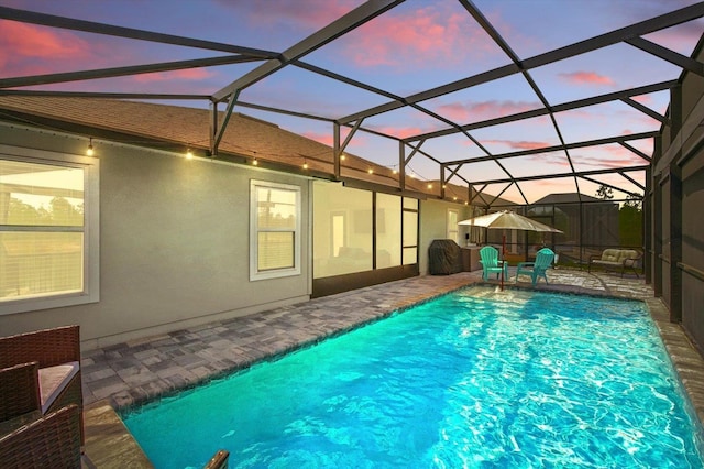 52 Lumberjack Trl, Palm Coast, FL 32137 - pool at dusk featuring an outdoor pool and a patio area