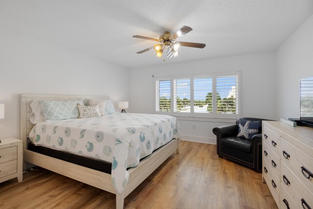 bedroom with light hardwood / wood-style floors and ceiling fan