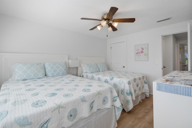 bedroom with light wood-type flooring and ceiling fan