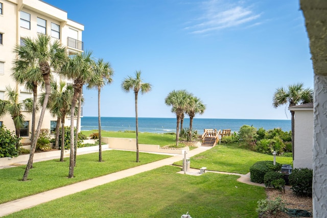 view of home's community featuring a water view and a lawn