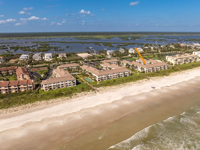 bird's eye view with a water view and a beach view