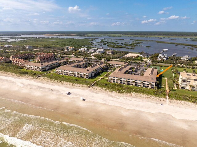 drone / aerial view featuring a water view and a beach view