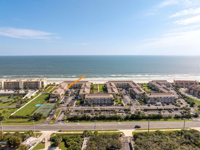 birds eye view of property featuring a water view and a beach view