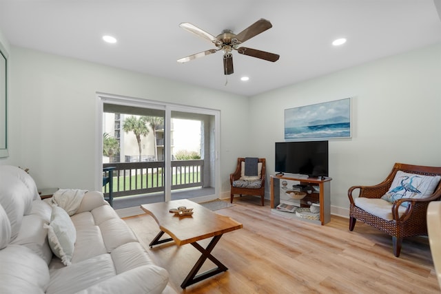 living room with ceiling fan and light hardwood / wood-style flooring