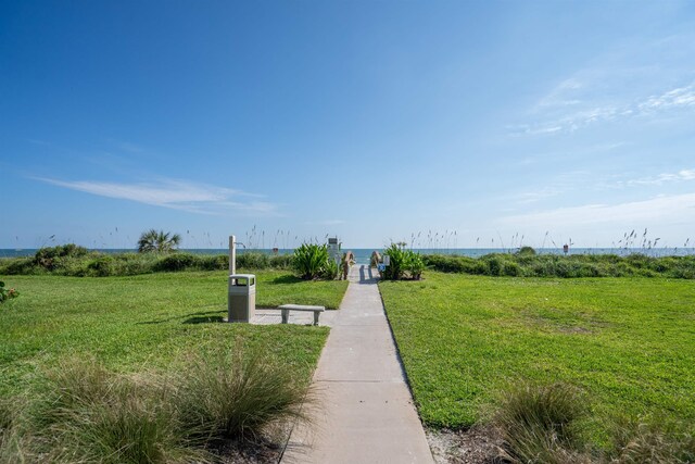 view of property's community featuring a water view and a lawn