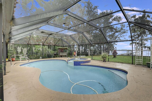 view of pool featuring glass enclosure, a patio area, and an in ground hot tub