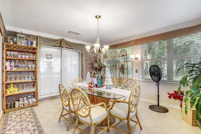 tiled dining room featuring an inviting chandelier