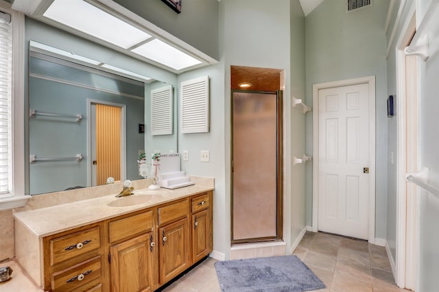 bathroom with vanity, tile patterned floors, and walk in shower