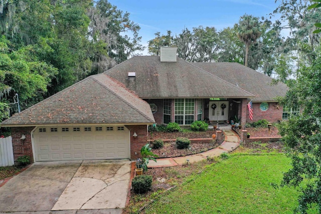 view of front of property with a garage and a front yard