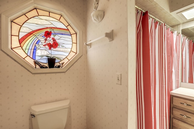 bathroom featuring vanity, a shower with shower curtain, and toilet