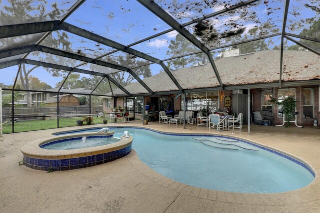 view of swimming pool featuring a lanai, an in ground hot tub, and a patio