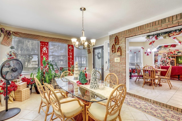 tiled dining area featuring brick wall and a notable chandelier