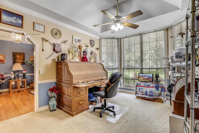 home office featuring ceiling fan with notable chandelier, wood-type flooring, a textured ceiling, and ornamental molding