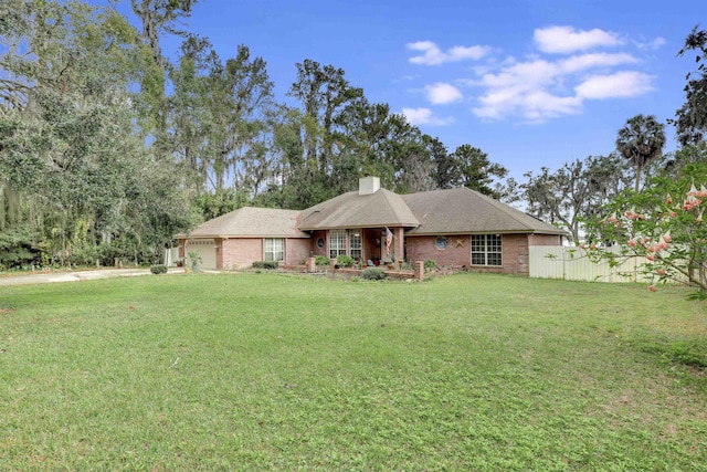 single story home with a garage and a front yard