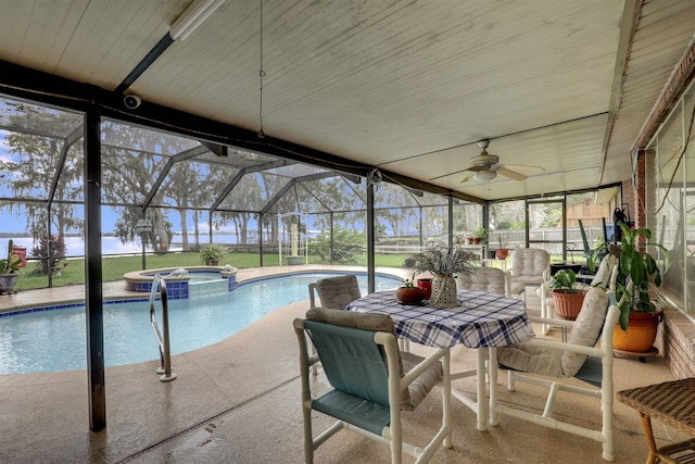 view of pool featuring glass enclosure, an in ground hot tub, and a patio