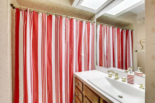 bathroom with a skylight and vanity