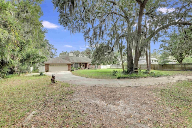 view of front of property featuring a front yard and a garage