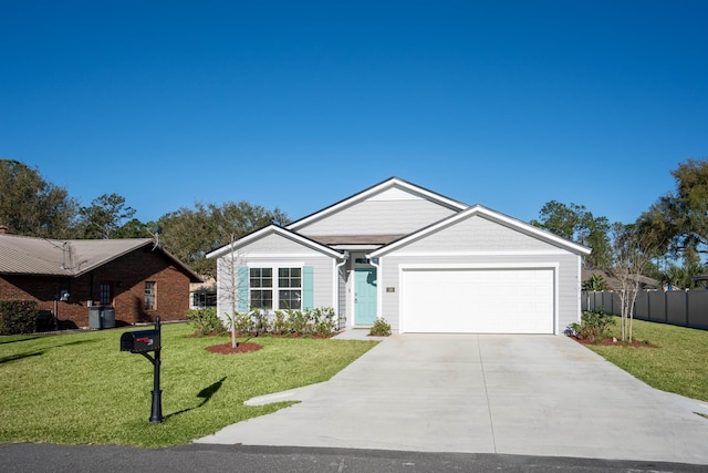 ranch-style home with a front lawn, fence, a garage, and driveway