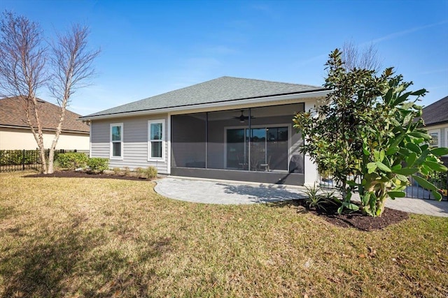 rear view of property with a yard, a sunroom, and ceiling fan