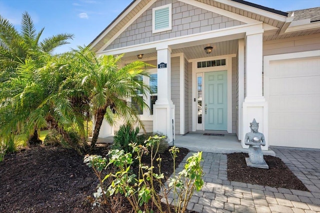 doorway to property with a garage