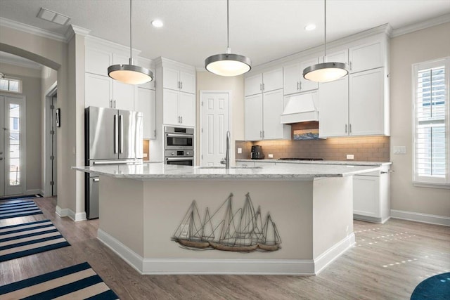 kitchen with white cabinetry, sink, a center island with sink, and premium range hood